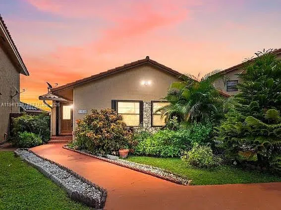 a view of a house with a yard and plants