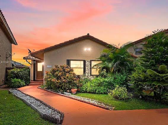a view of a house with a yard and plants