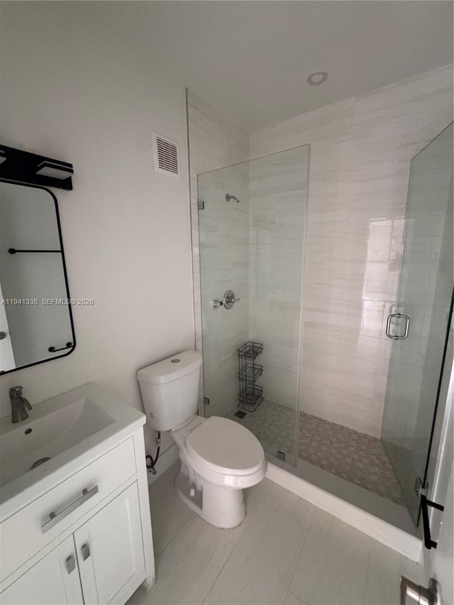 13528 Southwest 9th Lane Miami, FL 33184 - Photo 11 of 26 a white toilet sitting next to a bathroom sink