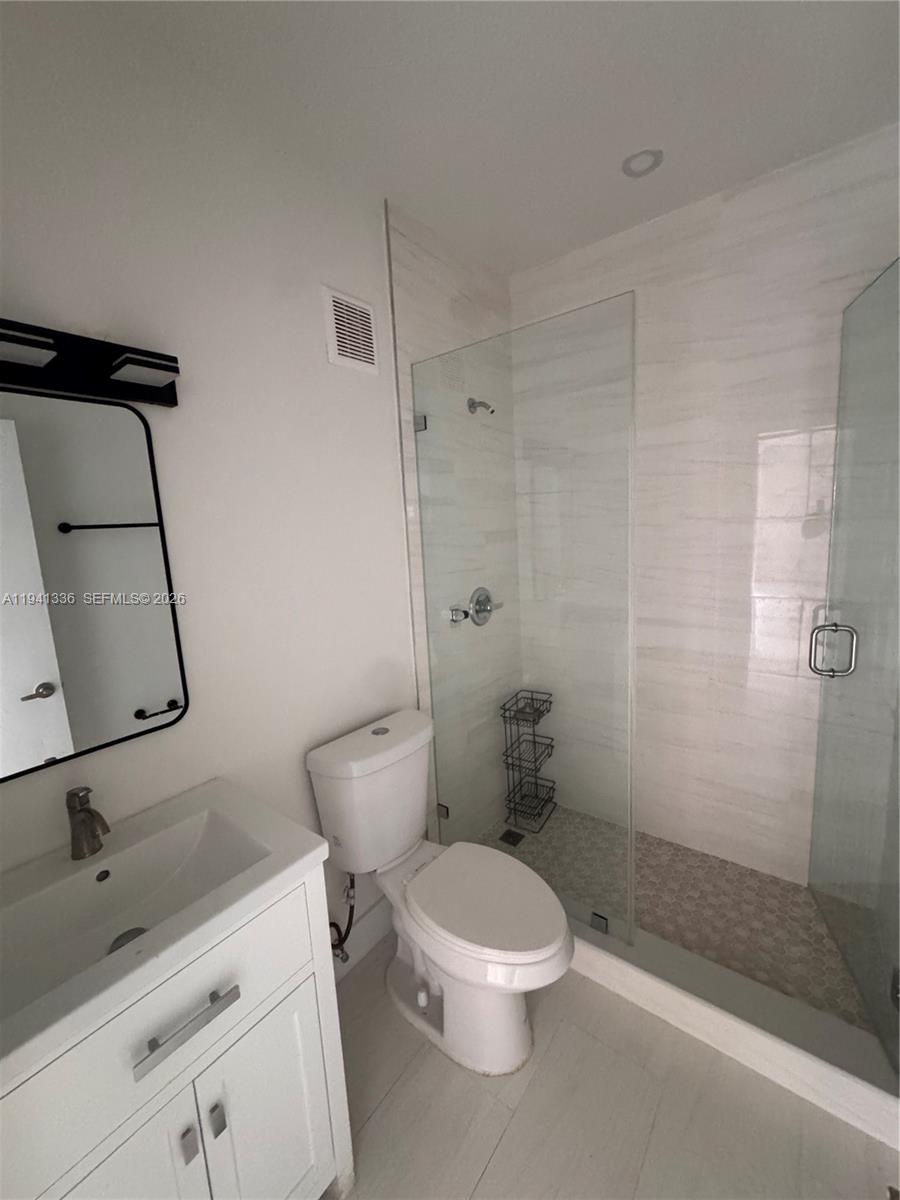 13528 Southwest 9th Lane Miami, FL 33184 - Photo 12 of 26 a white toilet sitting next to a bathroom sink