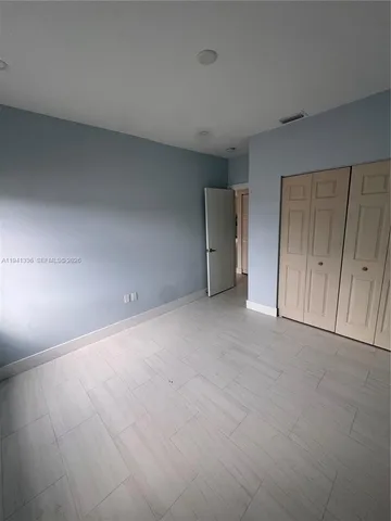 a view of an empty room and entryway
