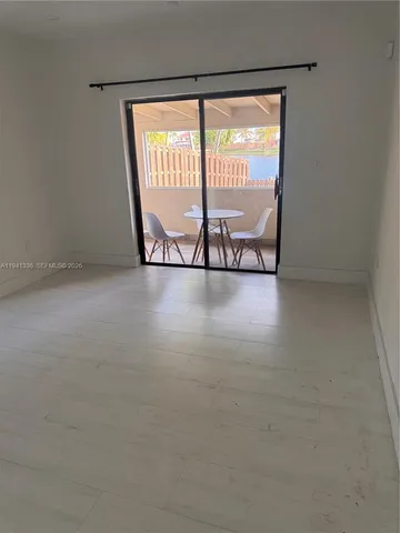 a view of an empty room with windows