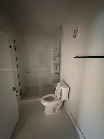 a white toilet sitting next to a bathroom sink