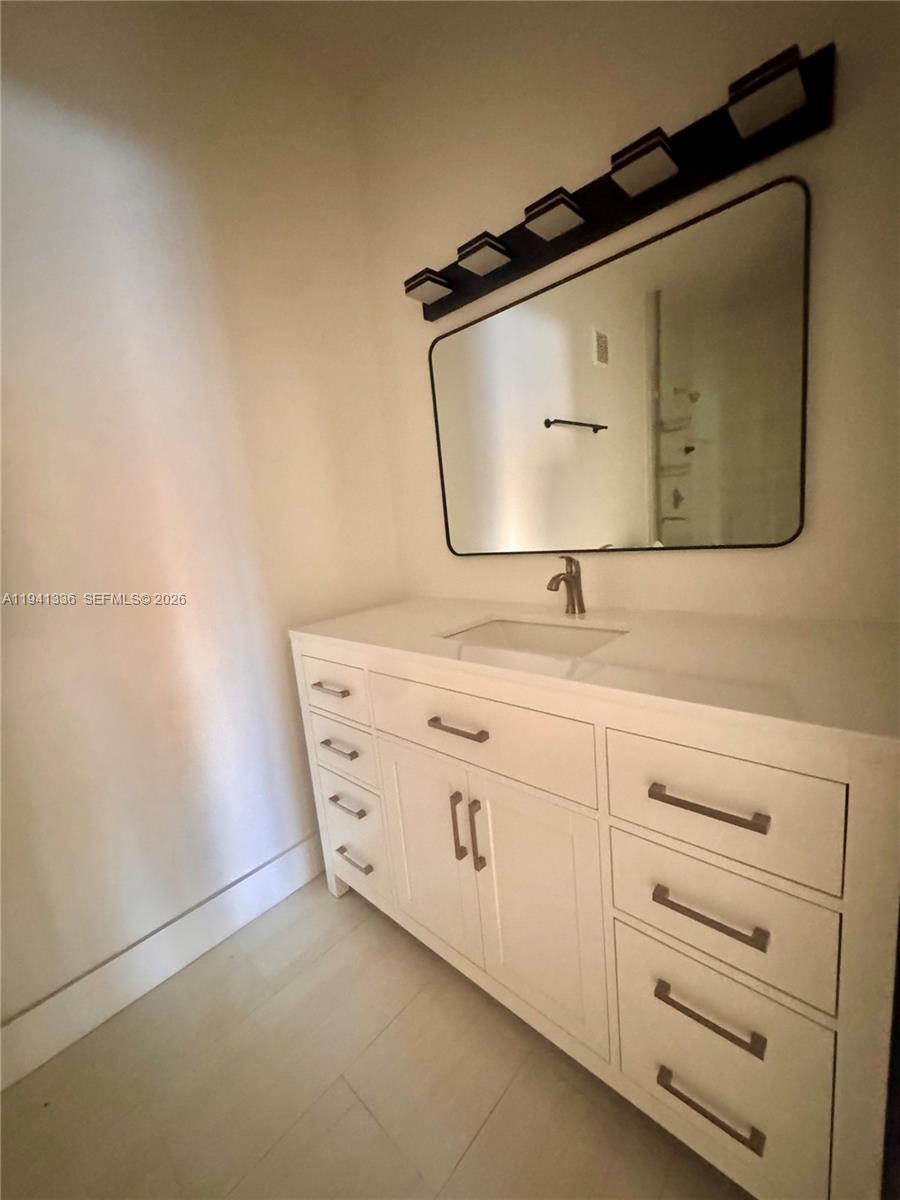 13528 Southwest 9th Lane Miami, FL 33184 - Photo 19 of 26 a bathroom with a mirror sink and vanity