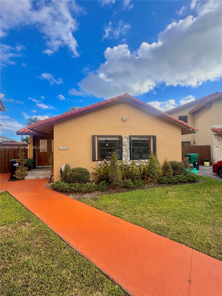 13528 Southwest 9th Lane Miami, FL 33184 - Photo 2 of 26 a front view of a house with a yard