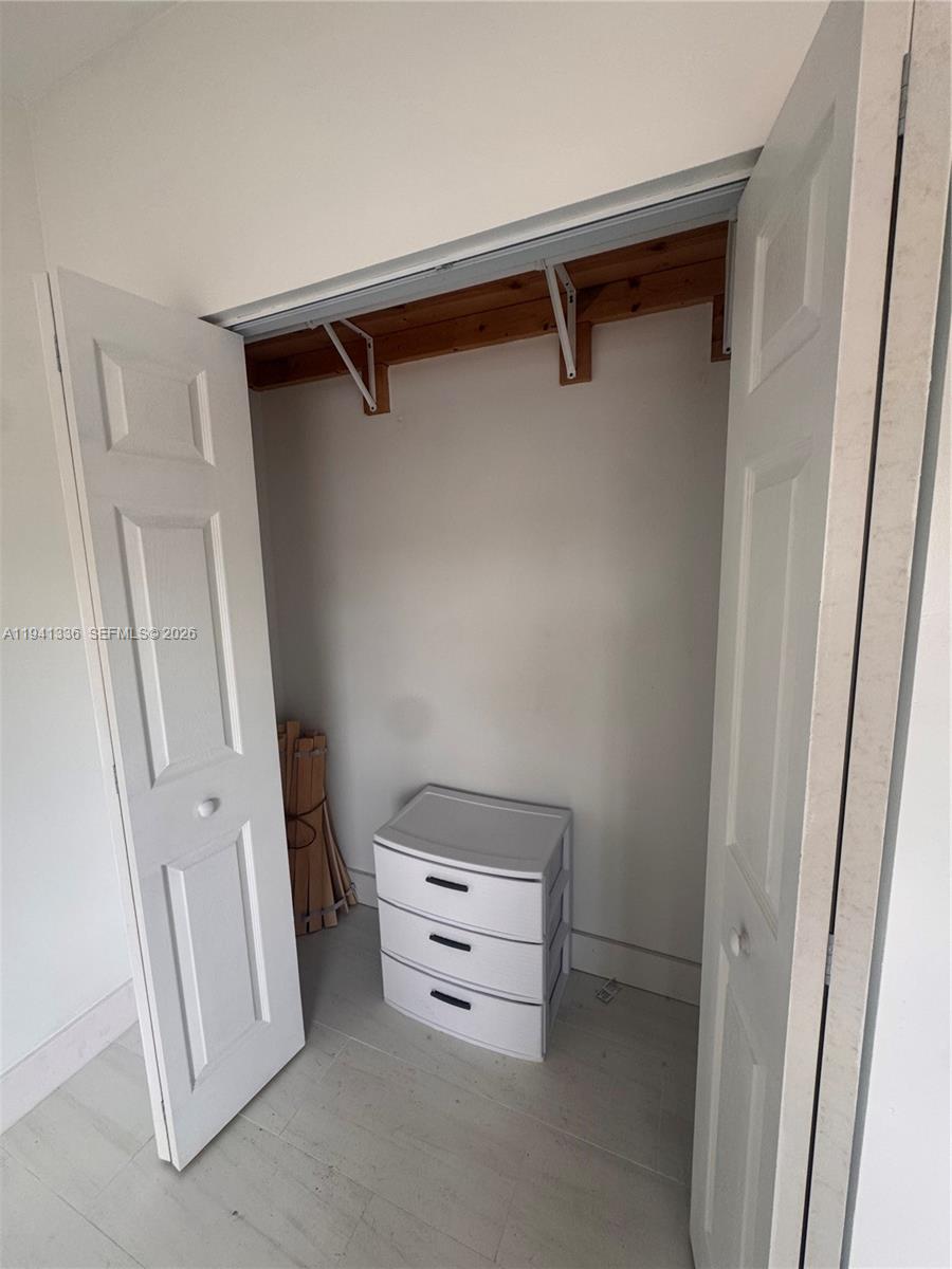 13528 Southwest 9th Lane Miami, FL 33184 - Photo 21 of 26 a view of walk in closet with empty racks