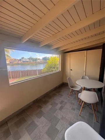 a view of a room with furniture and window