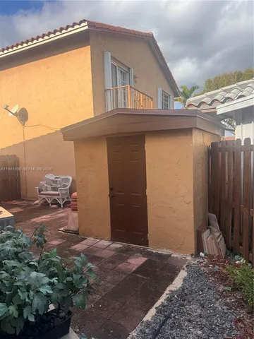 a backyard of a house with table and chairs