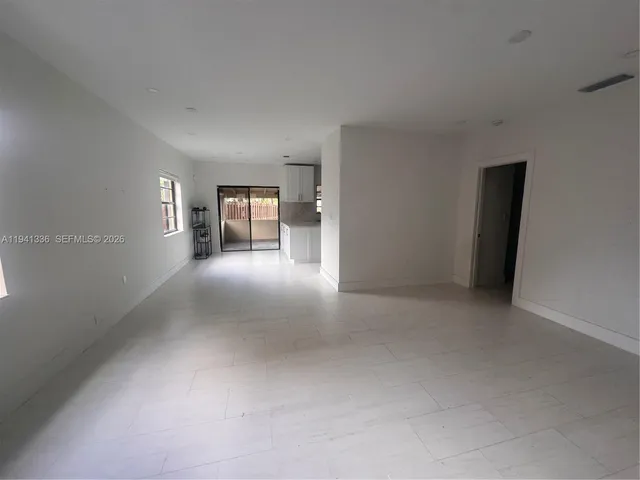 a view of a big room with closet and windows