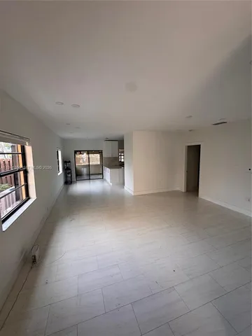 a view of a livingroom with furniture and staircase