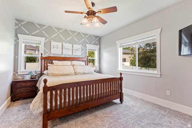 580 Cherry Ridge Lane Richmond, UT 84333 - Photo 15 of 53 Master bedroom with an accent wall, ceiling fan, and carpet floors