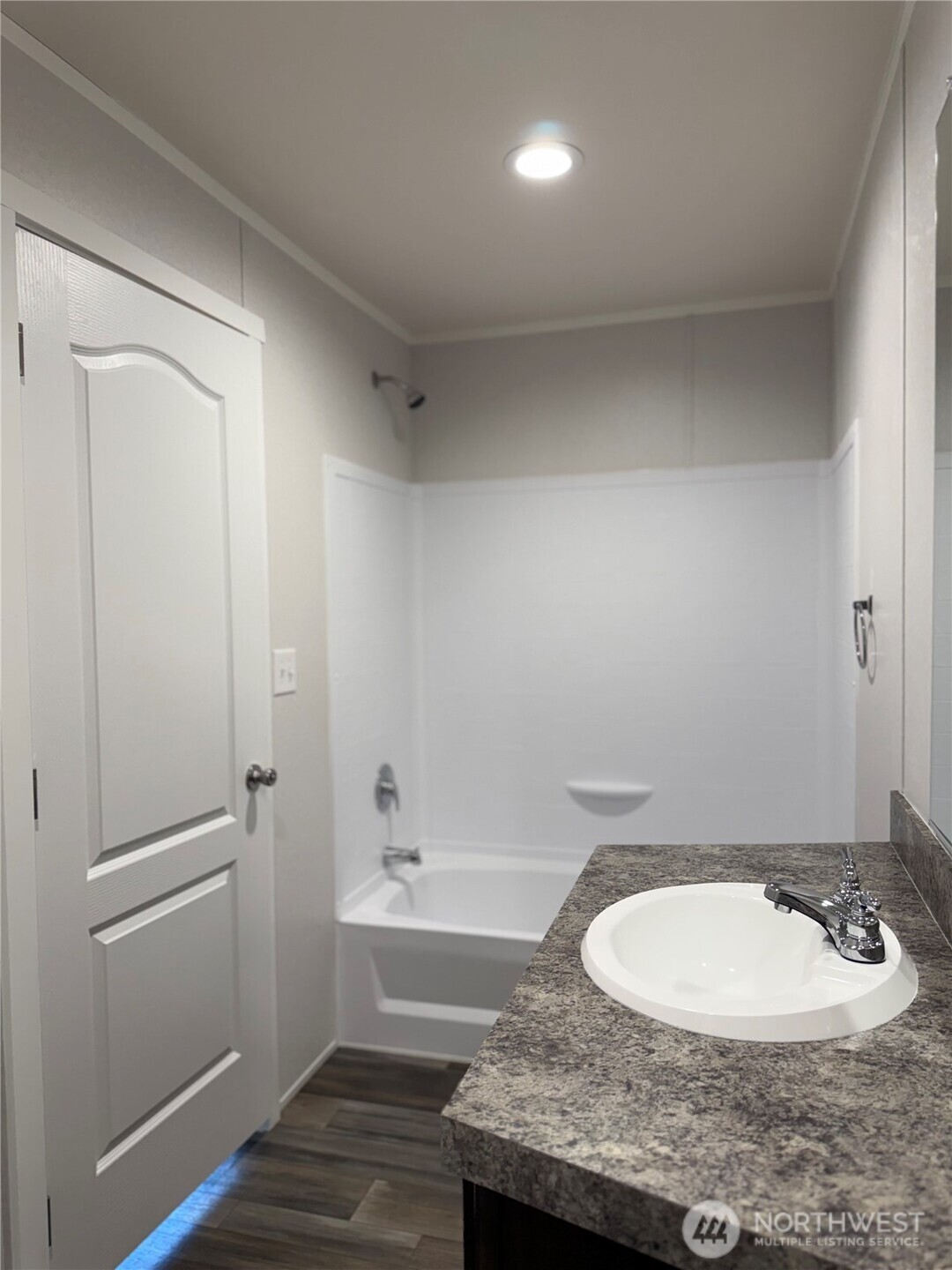 200 West Hawthorn Street, Unit 114 Connell, WA 99326 - Photo 16 of 16 a bathroom with a granite countertop sink and a mirror