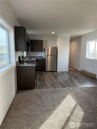 a large kitchen with stainless steel appliances granite countertop a refrigerator oven a sink and dishwasher