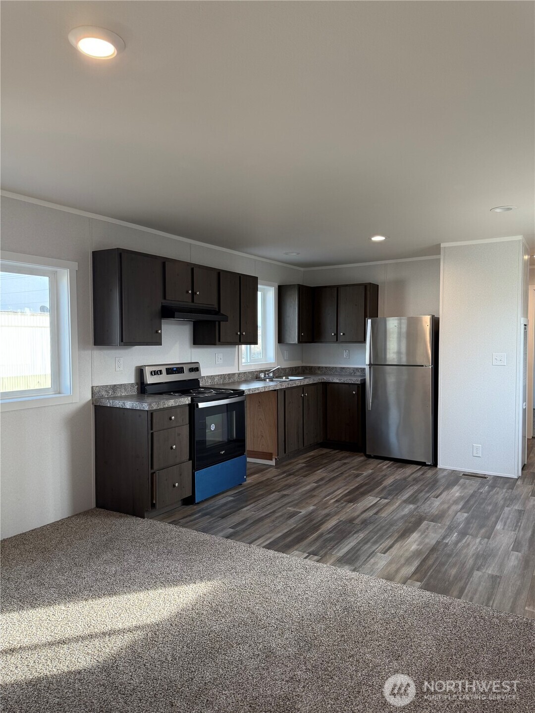 200 West Hawthorn Street, Unit 114 Connell, WA 99326 - Photo 9 of 16 a large kitchen with stainless steel appliances granite countertop a refrigerator oven a sink and dishwasher