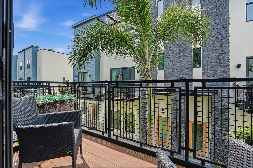 4810 West McElroy Avenue, Unit 30 Tampa, FL 33611 - Photo 5 of 43 a balcony with table and chairs