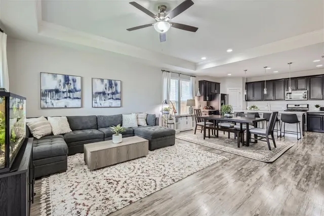 a living room with furniture and view of kitchen