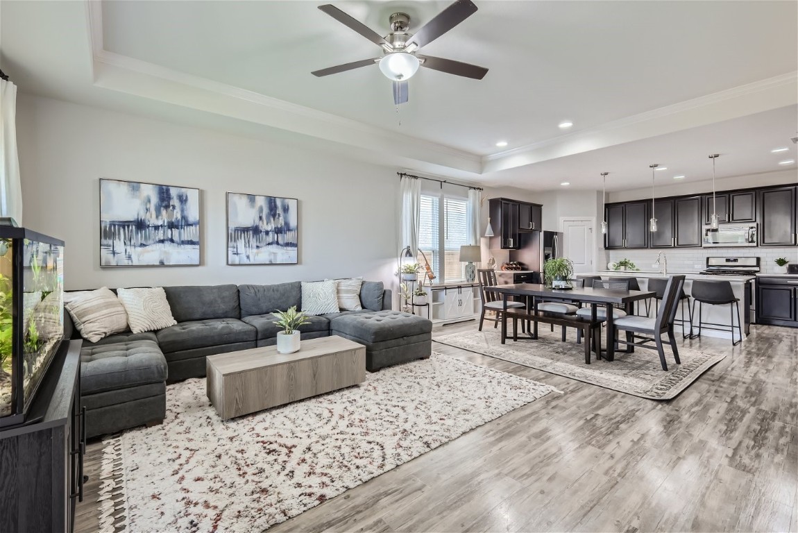 a living room with furniture and view of kitchen