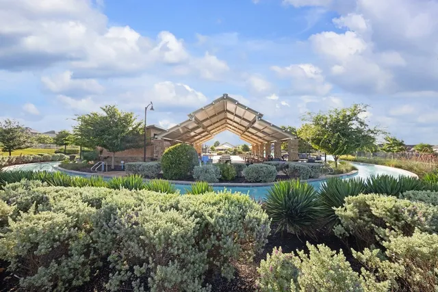 a front view of a house with a garden and patio