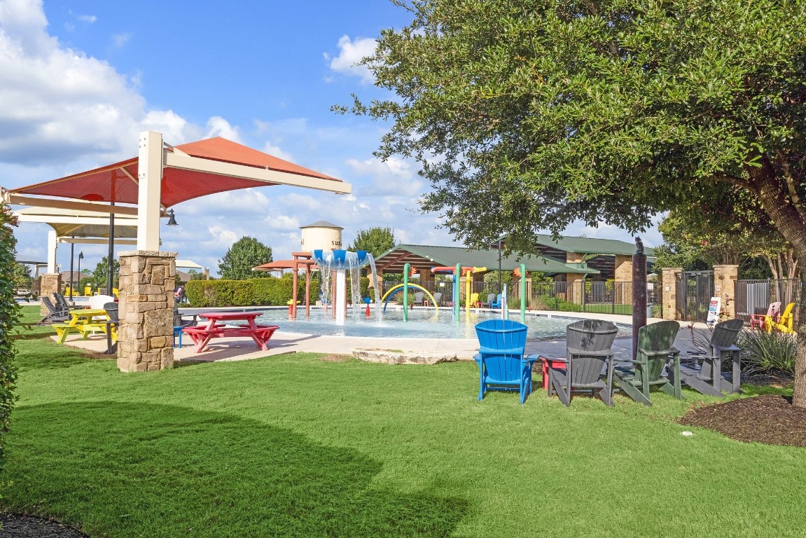 159 Bayberry Circle Buda, TX 78610 - Photo 13 of 29 a front view of a house with a garden and patio