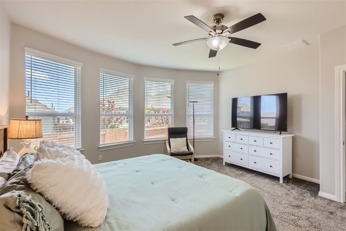 159 Bayberry Circle Buda, TX 78610 - Photo 17 of 29 a bedroom with a bed and a flat screen tv