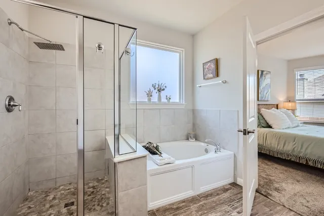 a bedroom with a bed and a ceiling fan