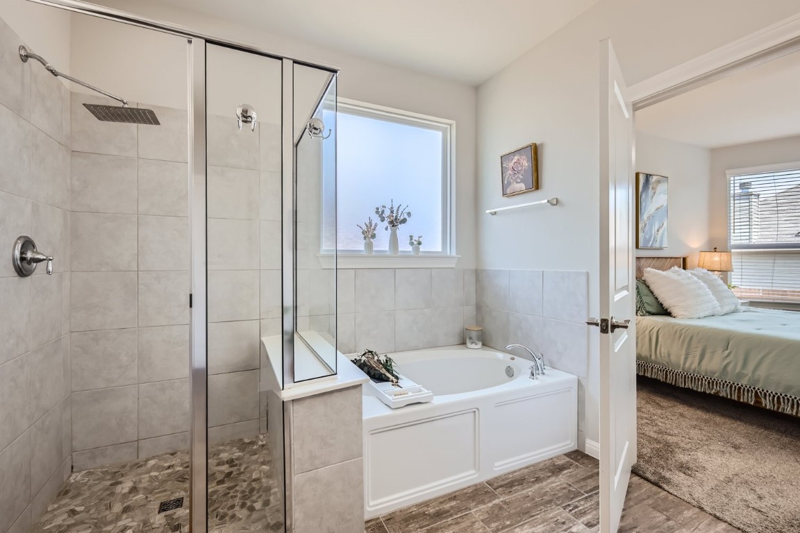 159 Bayberry Circle Buda, TX 78610 - Photo 20 of 29 a bathroom with a tub and a shower