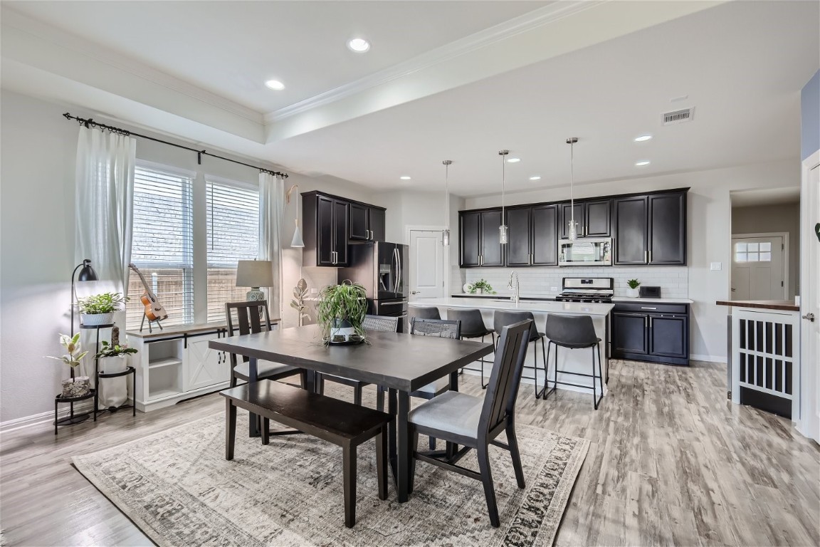 159 Bayberry Circle Buda, TX 78610 - Photo 2 of 29 a view of a dining room with furniture and wooden floor