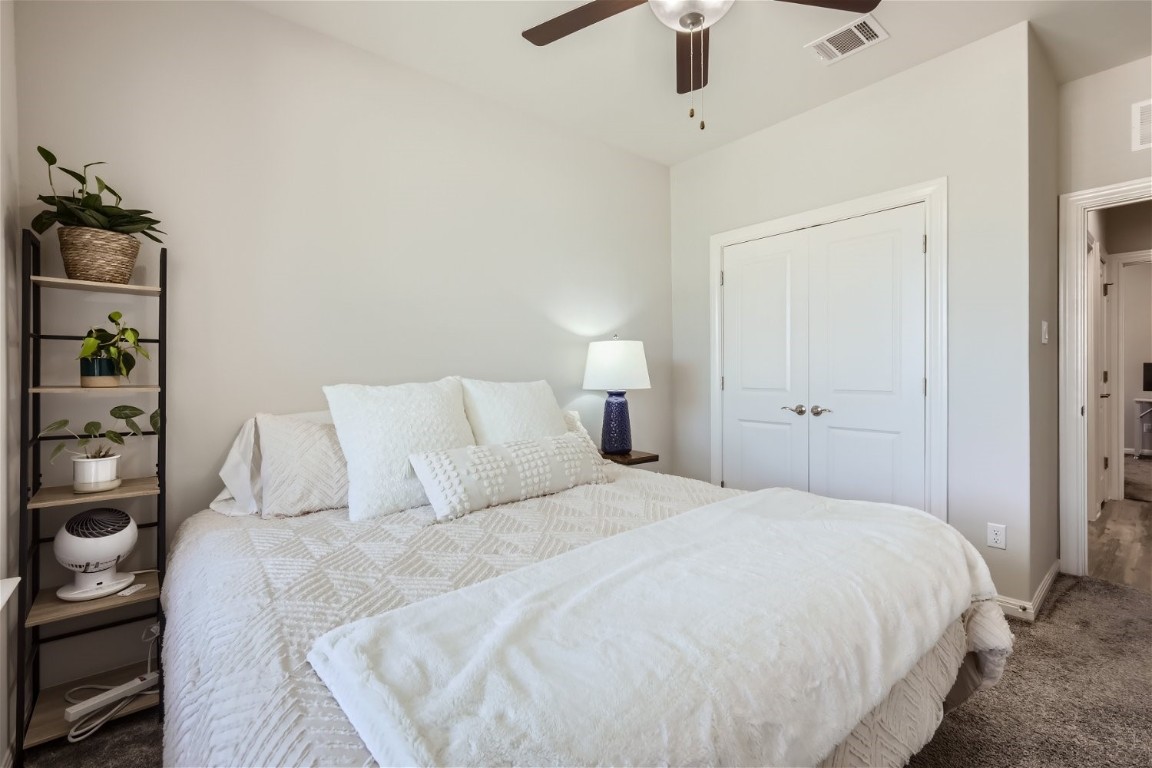 159 Bayberry Circle Buda, TX 78610 - Photo 22 of 29 a bedroom with a bed and a ceiling fan