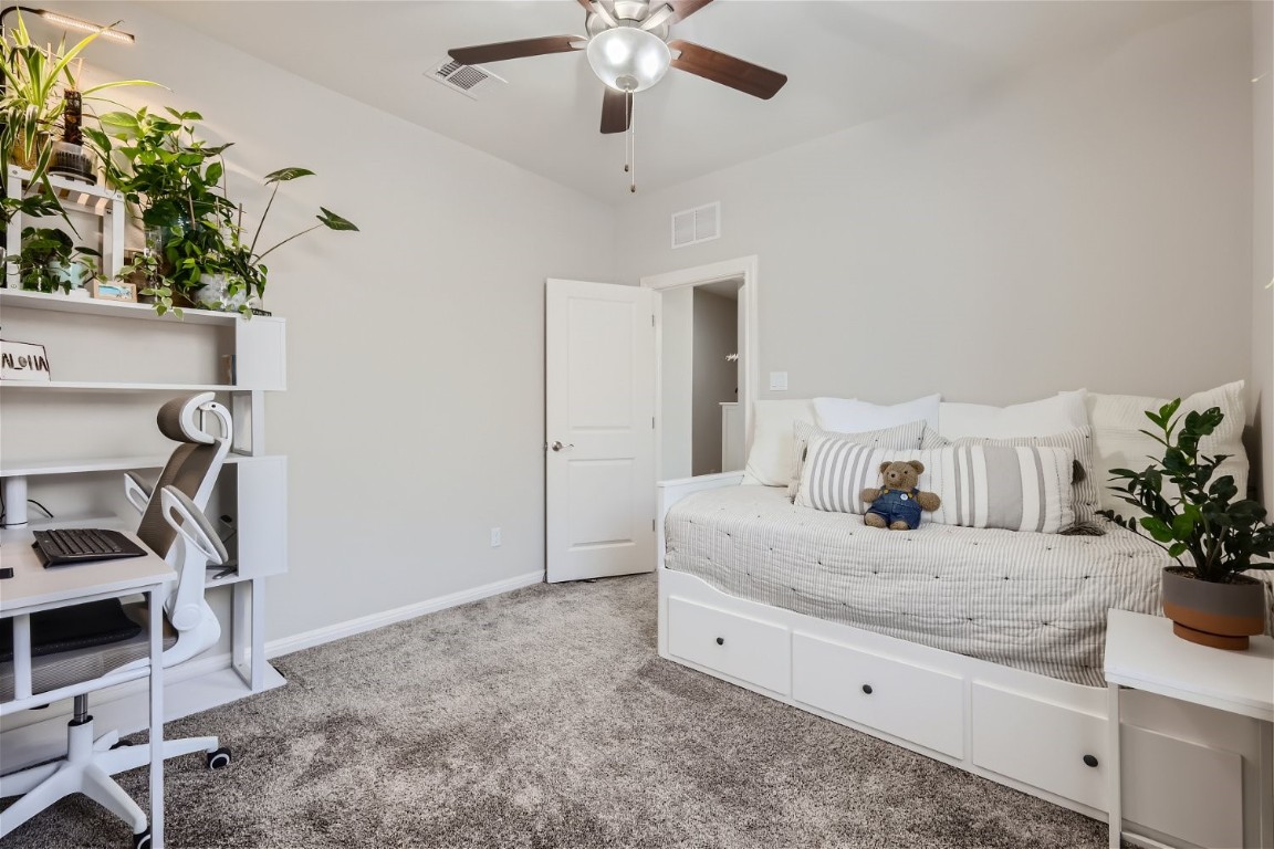 159 Bayberry Circle Buda, TX 78610 - Photo 24 of 29 a room with a chandelier furniture and a potted plant