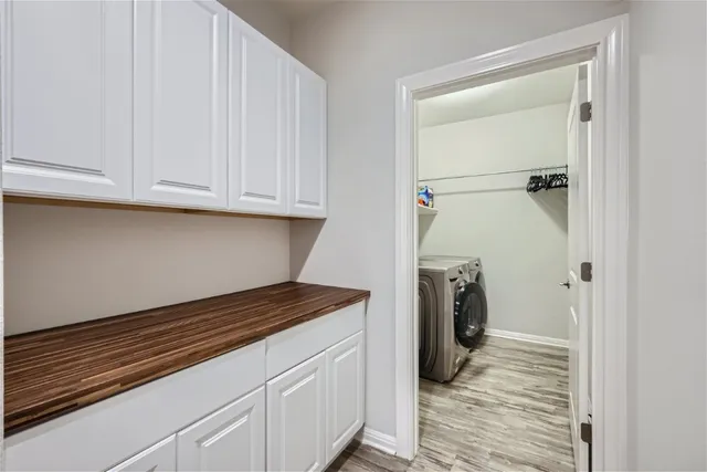 a view of a house with a big yard and potted plants