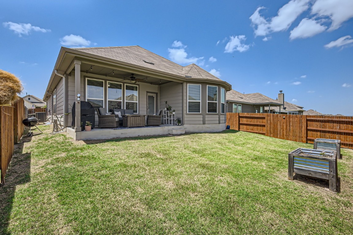 159 Bayberry Circle Buda, TX 78610 - Photo 27 of 29 a view of a house with a big yard and potted plants