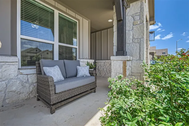 a view of a patio with couches and potted plants