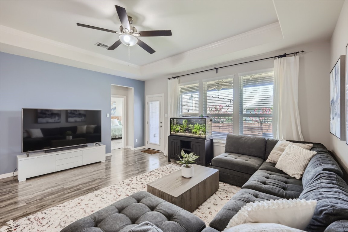 159 Bayberry Circle Buda, TX 78610 - Photo 6 of 29 a living room with furniture a flat screen tv and a fireplace