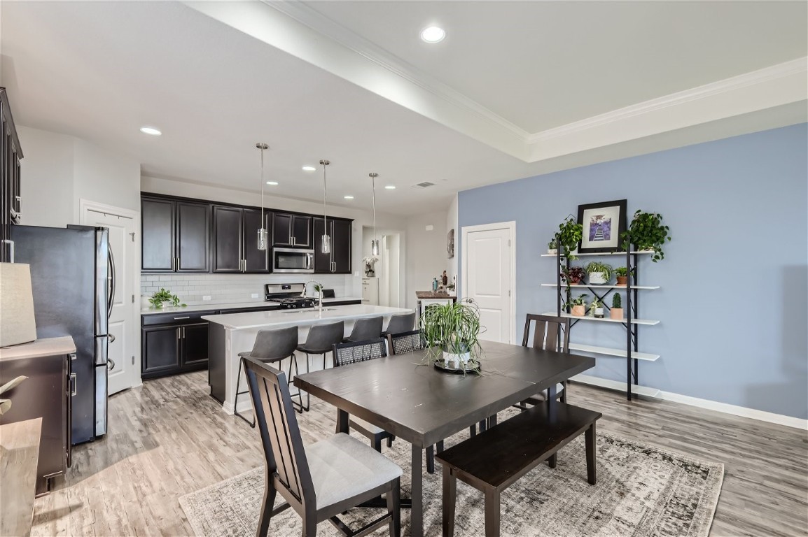 159 Bayberry Circle Buda, TX 78610 - Photo 7 of 29 a kitchen with a table and chairs in it