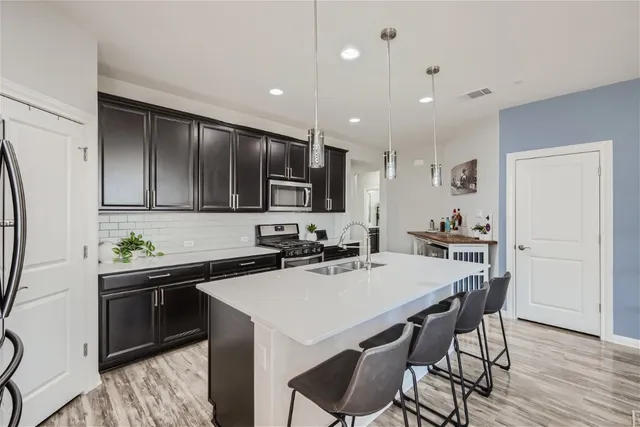a kitchen with a table chairs stove and cabinets