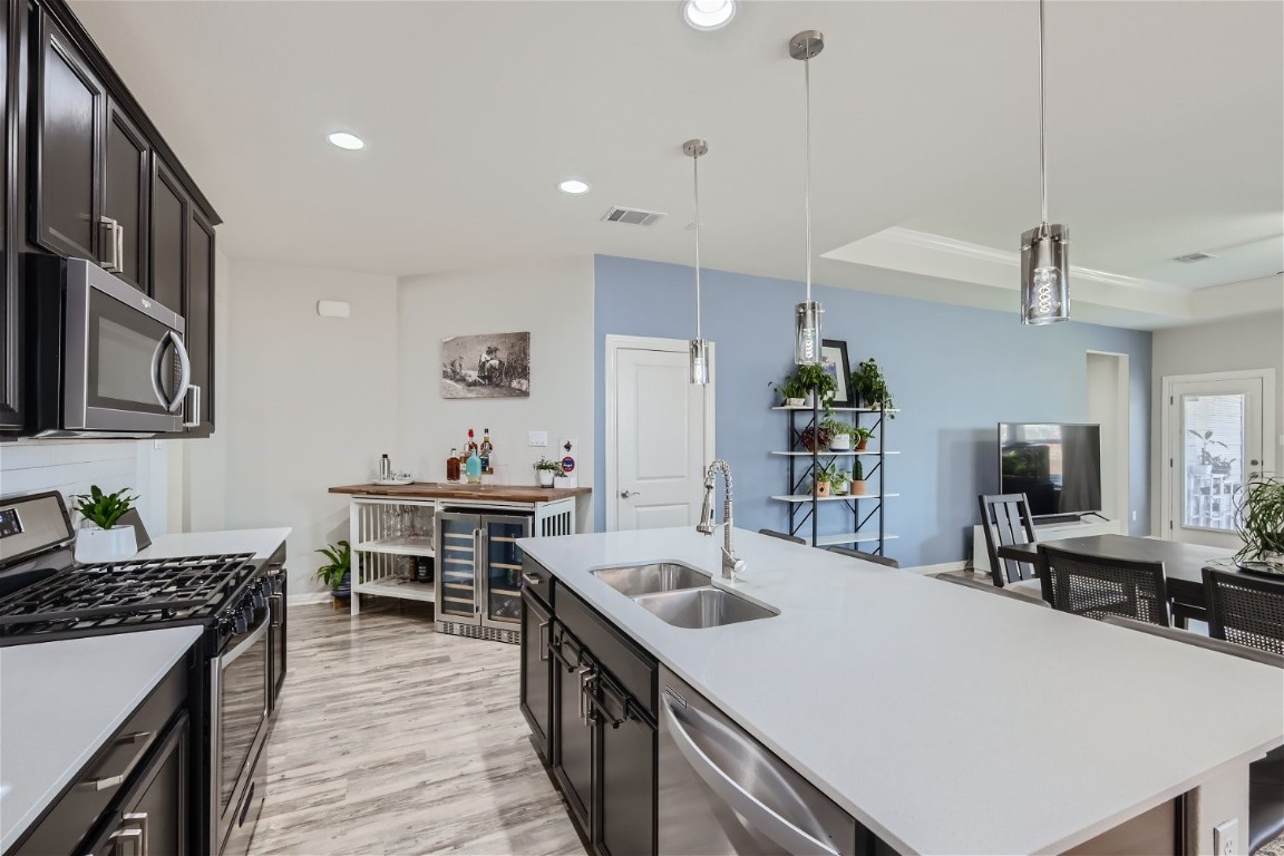 159 Bayberry Circle Buda, TX 78610 - Photo 10 of 29 a kitchen with a table chairs stove and cabinets