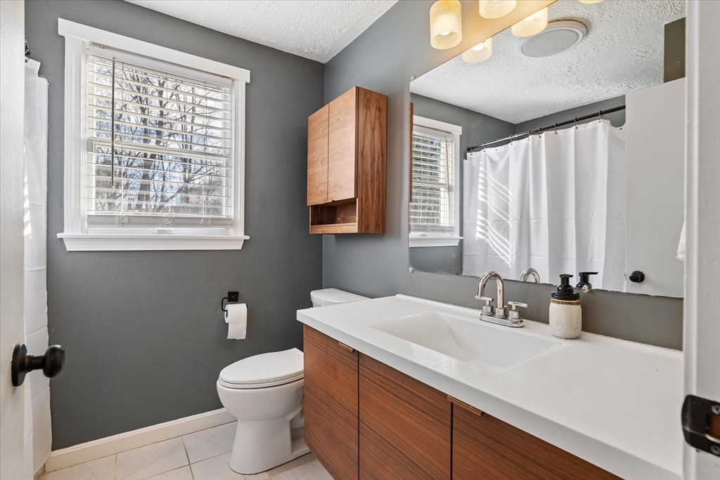 9 Hebert Road Spencer, MA 01562 - Photo 18 of 33 a bathroom with a sink a toilet and a large mirror