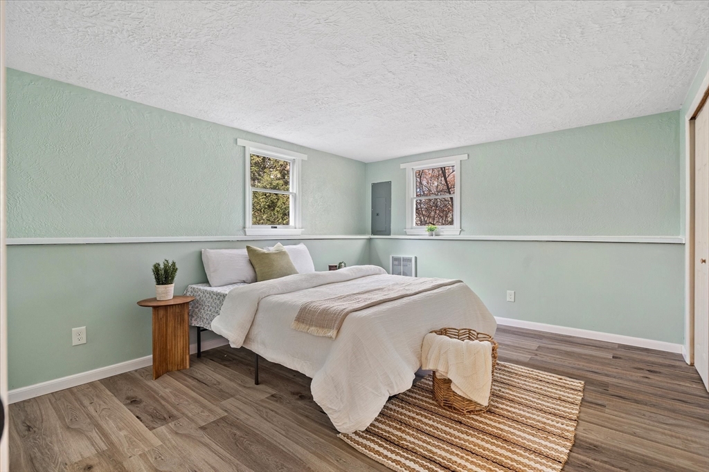 9 Hebert Road Spencer, MA 01562 - Photo 21 of 33 a bedroom with a bed and wooden floor