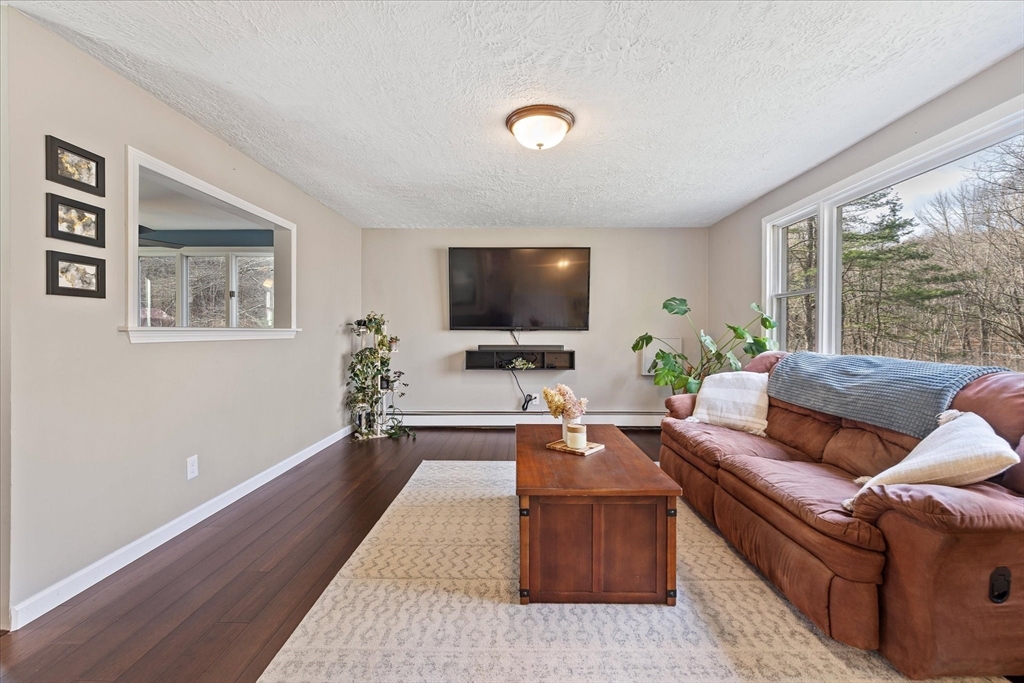 9 Hebert Road Spencer, MA 01562 - Photo 6 of 33 a living room with furniture and a flat screen tv