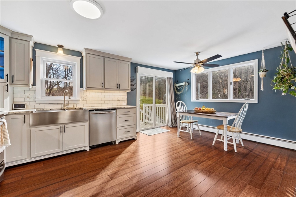 9 Hebert Road Spencer, MA 01562 - Photo 9 of 33 a kitchen with granite countertop wooden floors and white cabinets