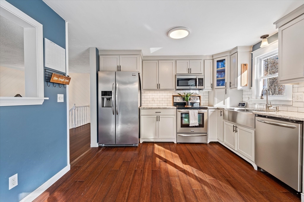 9 Hebert Road Spencer, MA 01562 - Photo 10 of 33 a kitchen with granite countertop a refrigerator and a stove top oven