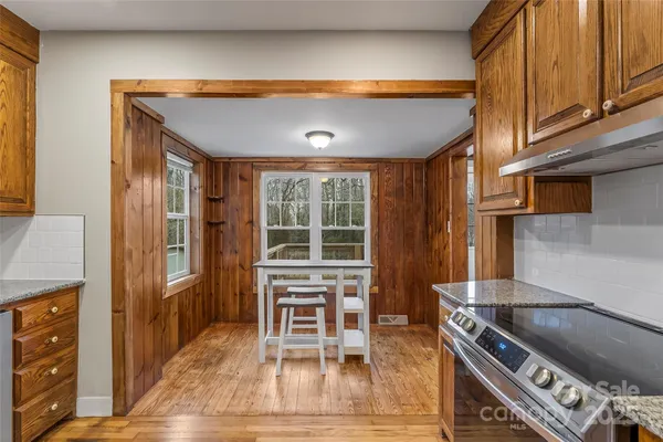 a kitchen with stainless steel appliances granite countertop a stove a refrigerator and a microwave