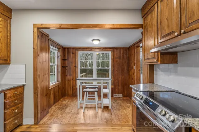 a kitchen with stainless steel appliances granite countertop a stove a refrigerator and a microwave