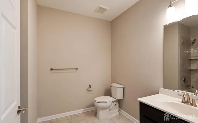 a bathroom with a sink toilet and vanity