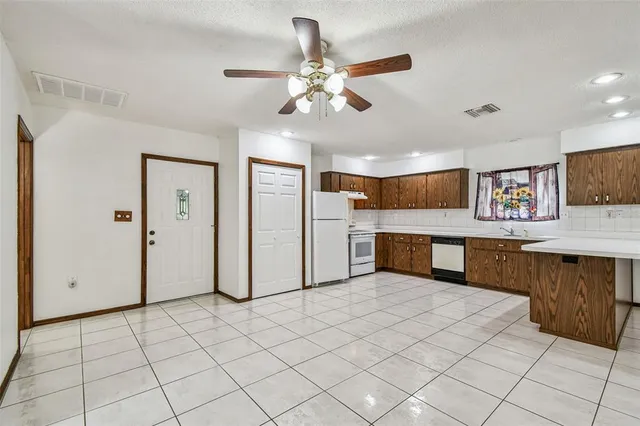 a kitchen with stainless steel appliances a refrigerator and microwave