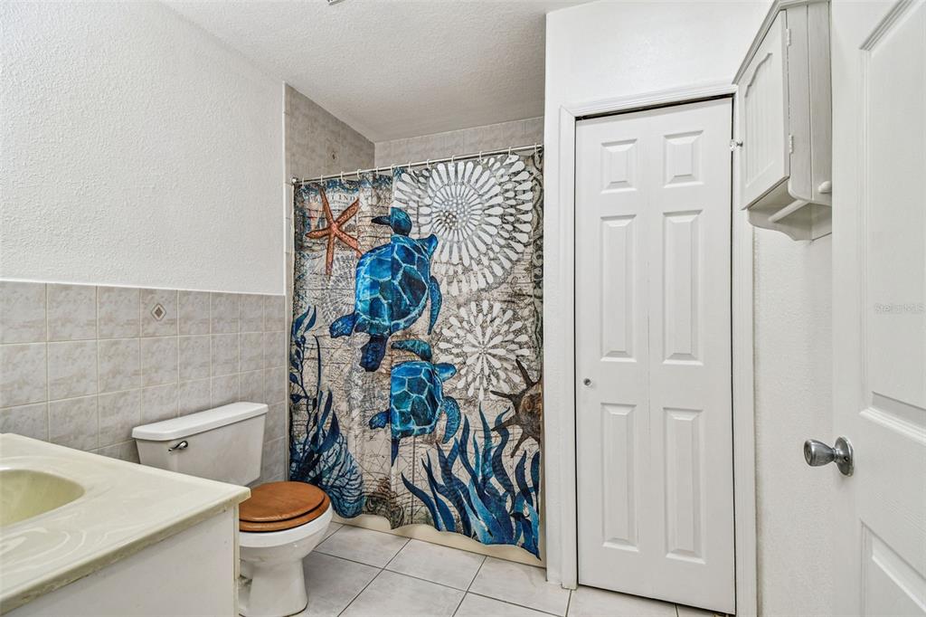 9741 Star Trail New Port Richey, FL 34654 - Photo 13 of 38 a white toilet sitting next to a bathroom sink