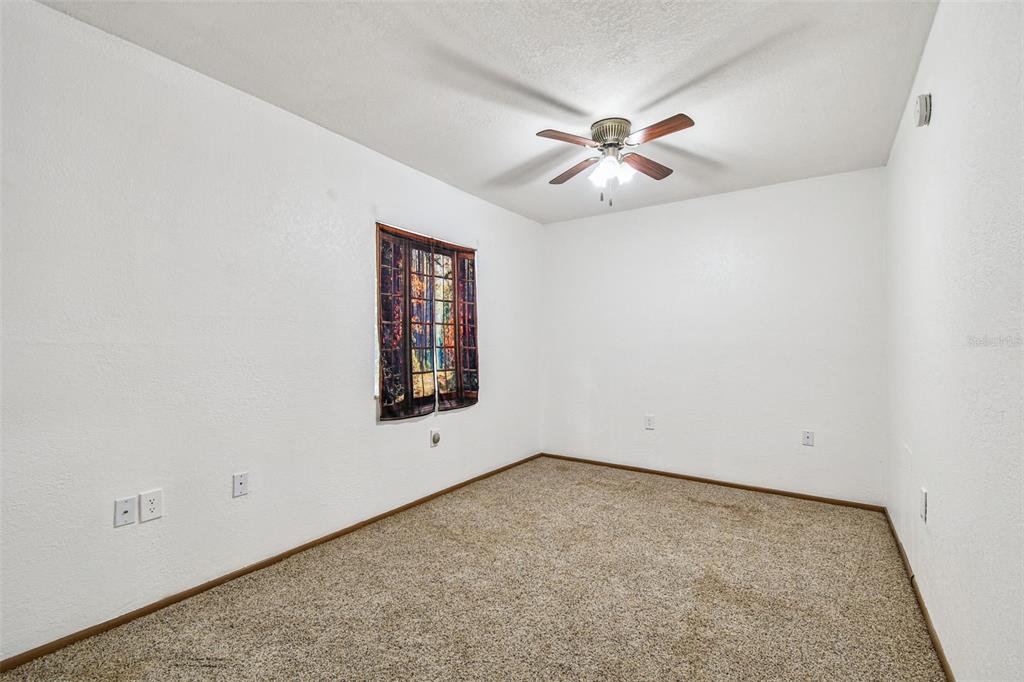 9741 Star Trail New Port Richey, FL 34654 - Photo 14 of 38 an empty room with windows and fan