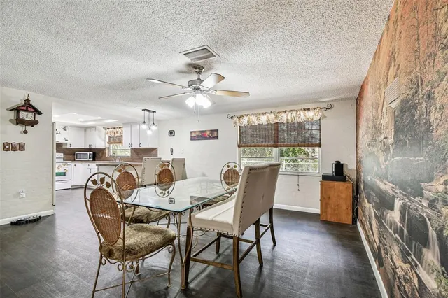 a dining room with furniture and window