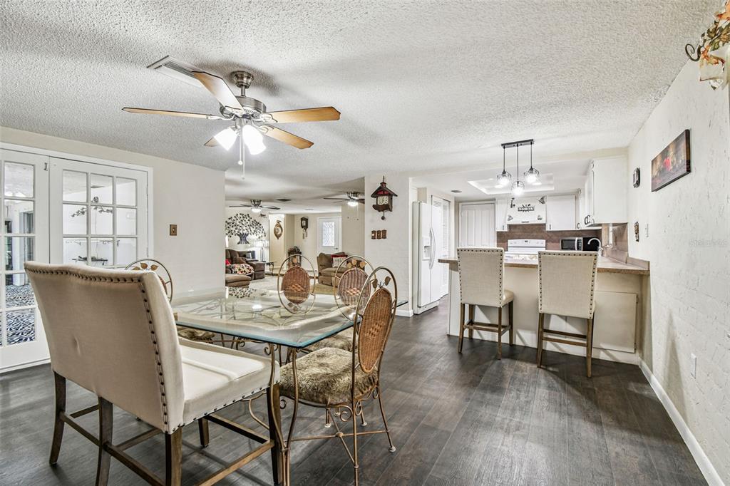 9741 Star Trail New Port Richey, FL 34654 - Photo 25 of 38 a view of a dining room with furniture and wooden floor
