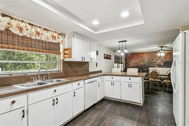 a large white kitchen with a large window